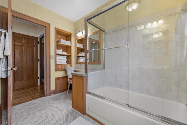 304 16th St, Racine, WI 53403 - bathroom with enclosed tub / shower combo, built in shelves, vanity, and baseboards