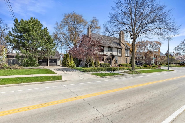 304 16th St, Racine, WI 53403 - view of front of home with concrete driveway, a garage, a chimney, and a residential view