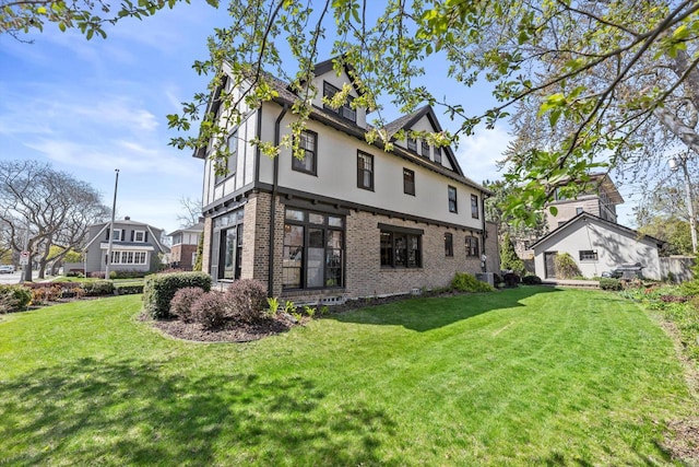 304 16th St, Racine, WI 53403 - view of property exterior featuring stucco siding, a lawn, brick siding, and central AC