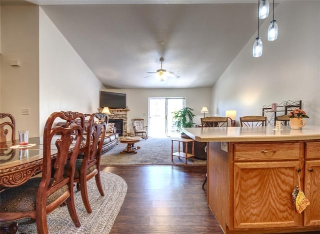 429 Riggs St, Bloomer, WI 54724 - dining area with a fireplace, a ceiling fan, dark wood-style flooring, and lofted ceiling
