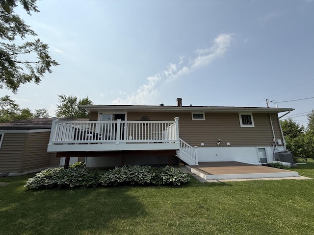 528 High St, Walworth, WI 53184 - rear view of house featuring a deck, central AC, and a lawn