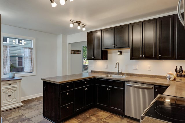 kitchen featuring stainless steel dishwasher, a sink, plenty of natural light, and a peninsula
