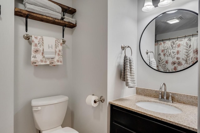 full bathroom with toilet and vanity