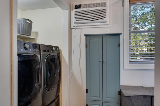 laundry area with washer and clothes dryer, cabinet space, and a wall mounted AC