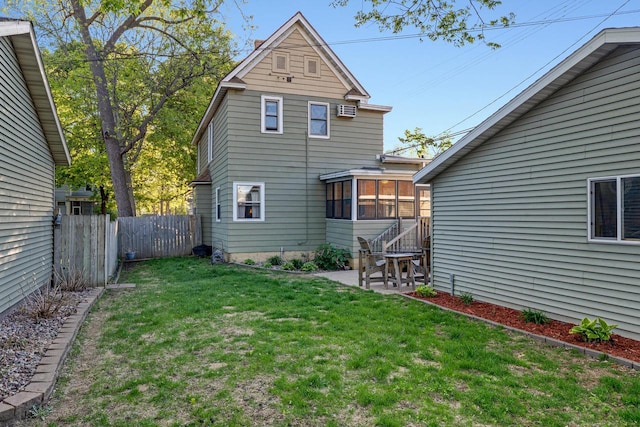 back of house featuring a sunroom and a patio