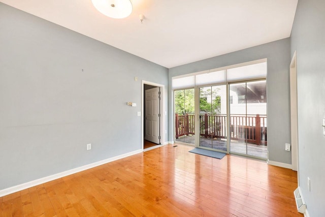 612 N Midvale Blvd, Madison, WI 53705 - unfurnished room featuring wood finished floors, baseboards, and a pendent fire sprinkler