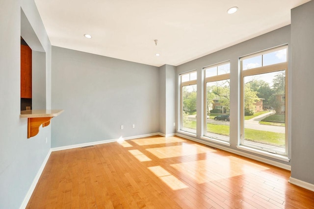 612 N Midvale Blvd, Madison, WI 53705 - unfurnished living room featuring baseboards, light wood finished floors, and recessed lighting