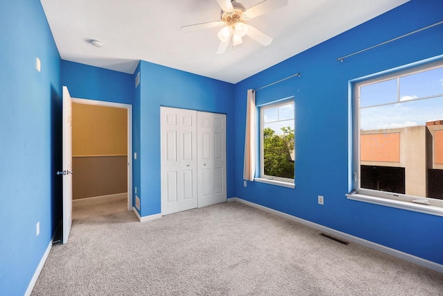 612 N Midvale Blvd, Madison, WI 53705 - unfurnished bedroom featuring carpet, a closet, baseboards, and a ceiling fan