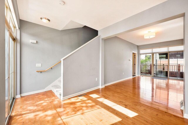 612 N Midvale Blvd, Madison, WI 53705 - unfurnished living room featuring baseboards, stairs, and wood finished floors