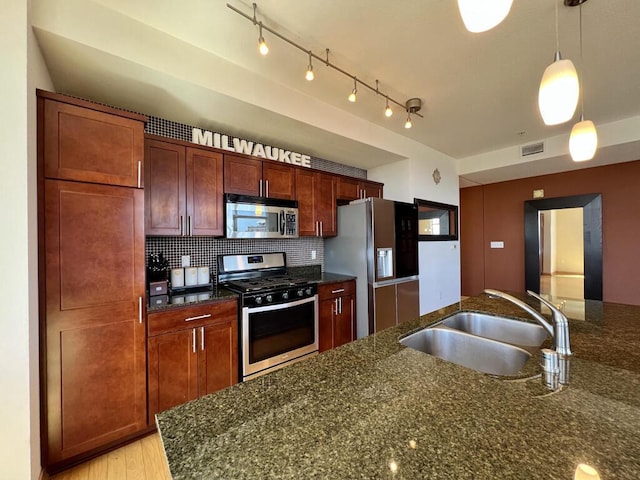 106 W Seeboth St Unit 503, Milwaukee, WI 53204 - kitchen with stainless steel appliances, a sink, tasteful backsplash, pendant lighting, and dark stone countertops