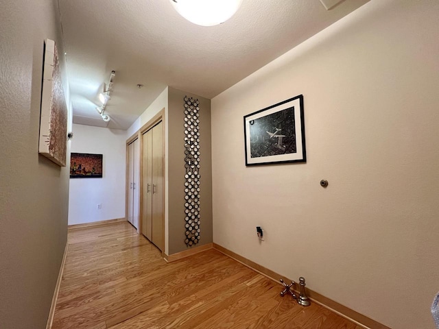 106 W Seeboth St Unit 503, Milwaukee, WI 53204 - hall featuring light wood-style flooring, baseboards, and rail lighting