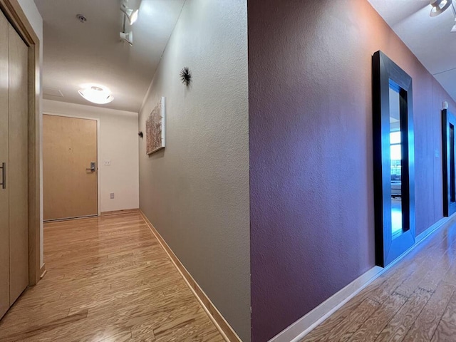 106 W Seeboth St Unit 503, Milwaukee, WI 53204 - hall featuring wood finished floors, a textured wall, and baseboards