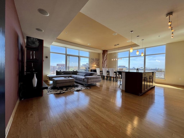 106 W Seeboth St Unit 503, Milwaukee, WI 53204 - living area featuring dark wood-style flooring, plenty of natural light, baseboards, and expansive windows