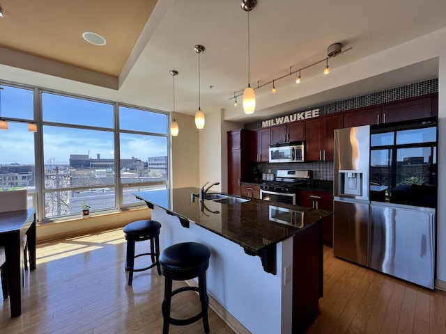 106 W Seeboth St Unit 503, Milwaukee, WI 53204 - kitchen featuring stainless steel appliances, a sink, hardwood / wood-style floors, and decorative backsplash