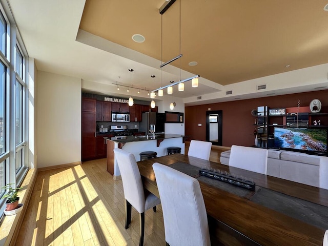 106 W Seeboth St Unit 503, Milwaukee, WI 53204 - dining room with light wood-type flooring, baseboards, and track lighting