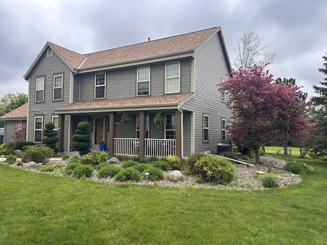 W308S2787 Wild Berry Ct, Waukesha, WI 53188 - view of front of house with covered porch, a front lawn, and roof with shingles