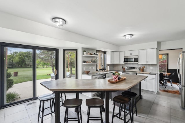 W308S2787 Wild Berry Ct, Waukesha, WI 53188 - kitchen featuring appliances with stainless steel finishes, a sink, plenty of natural light, and open shelves