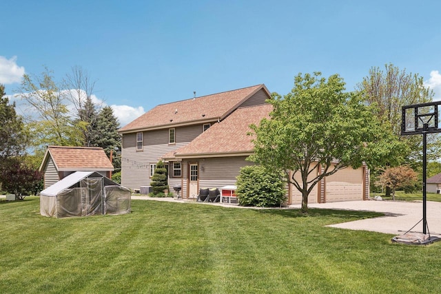 W308S2787 Wild Berry Ct, Waukesha, WI 53188 - rear view of property with concrete driveway, a yard, and roof with shingles