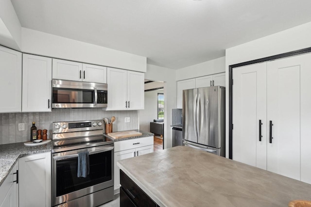 W308S2787 Wild Berry Ct, Waukesha, WI 53188 - kitchen featuring appliances with stainless steel finishes, backsplash, and white cabinets