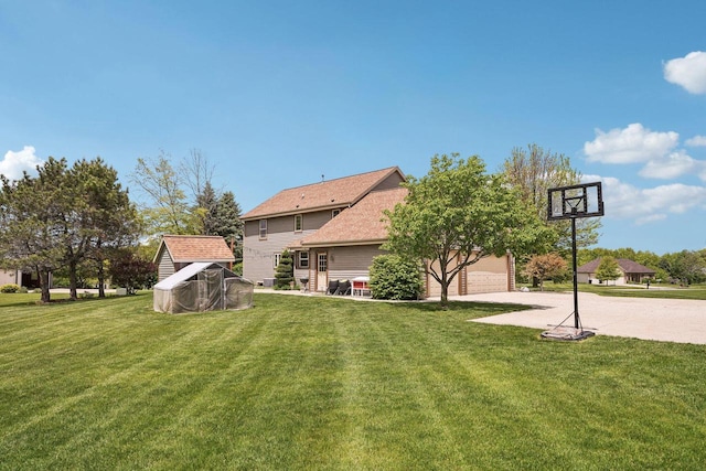 W308S2787 Wild Berry Ct, Waukesha, WI 53188 - back of property with concrete driveway, a yard, and a garage