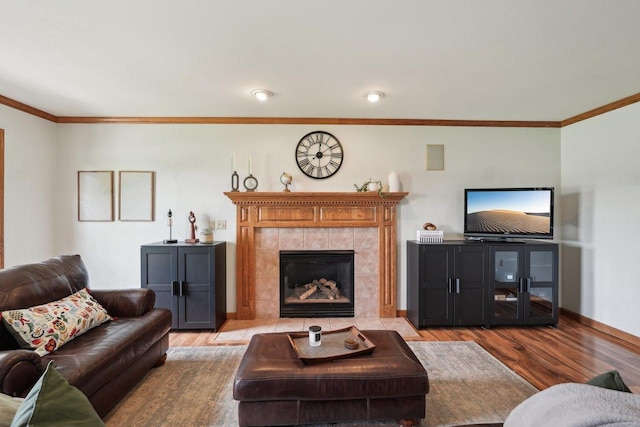 W308S2787 Wild Berry Ct, Waukesha, WI 53188 - living area with light wood-type flooring, crown molding, a tiled fireplace, and baseboards