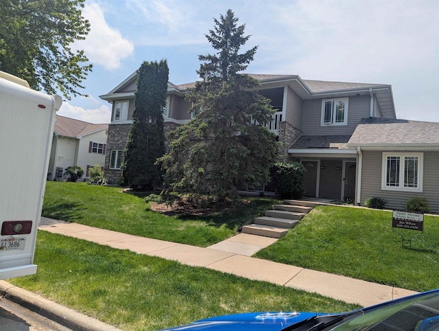 802 Herndon Dr Unit C, Madison, WI 53718 - view of front of property with a front yard, stone siding, and roof with shingles