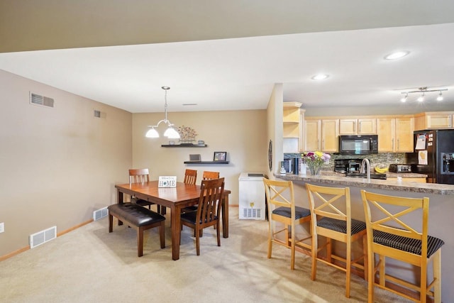 802 Herndon Dr Unit C, Madison, WI 53718 - dining area with a chandelier, light carpet, baseboards, and recessed lighting