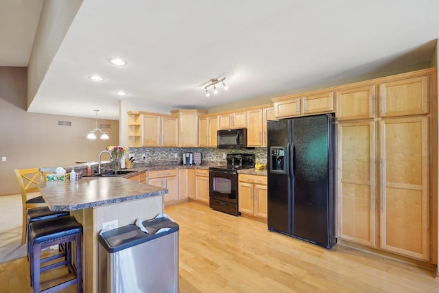 802 Herndon Dr Unit C, Madison, WI 53718 - kitchen with black appliances, light brown cabinets, a sink, a peninsula, and open shelves