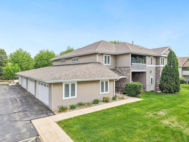 802 Herndon Dr Unit C, Madison, WI 53718 - view of front of home with a front lawn, roof with shingles, and a garage