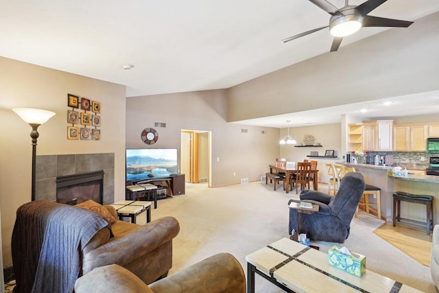 802 Herndon Dr Unit C, Madison, WI 53718 - living room with ceiling fan, a tiled fireplace, high vaulted ceiling, light colored carpet, and recessed lighting