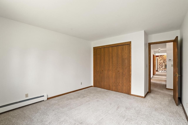 9 Sandalwood Ct, Wind Point, WI 53402 - unfurnished bedroom featuring a baseboard heating unit, light carpet, a closet, and baseboards