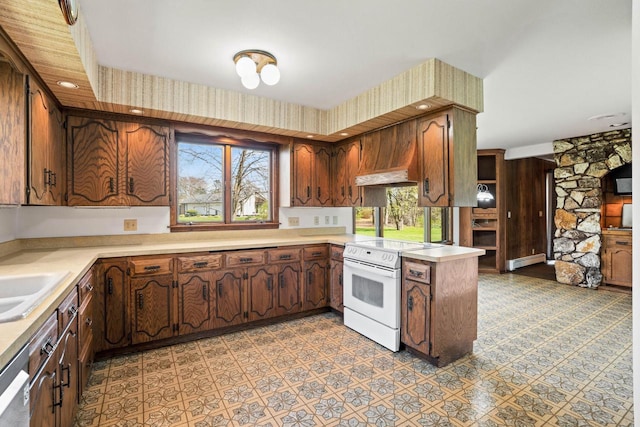 9 Sandalwood Ct, Wind Point, WI 53402 - kitchen with white range with electric stovetop, a baseboard radiator, light countertops, stainless steel dishwasher, and a peninsula
