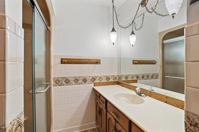 9 Sandalwood Ct, Wind Point, WI 53402 - full bath with tile walls, a shower stall, vanity, and wainscoting