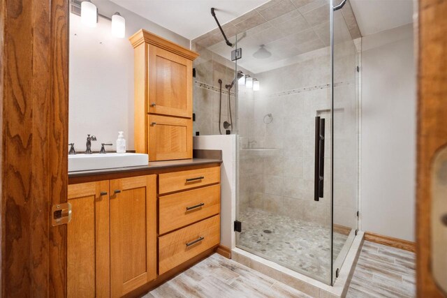1820 Sampson St, Wisconsin Rapids, WI 54494 - full bathroom with a stall shower, wood finished floors, and vanity