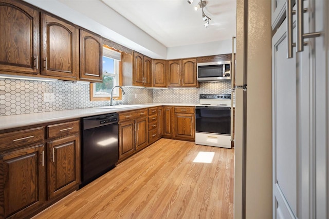 1820 Sampson St, Wisconsin Rapids, WI 54494 - kitchen featuring electric range, dishwasher, stainless steel microwave, a sink, and light wood-style flooring