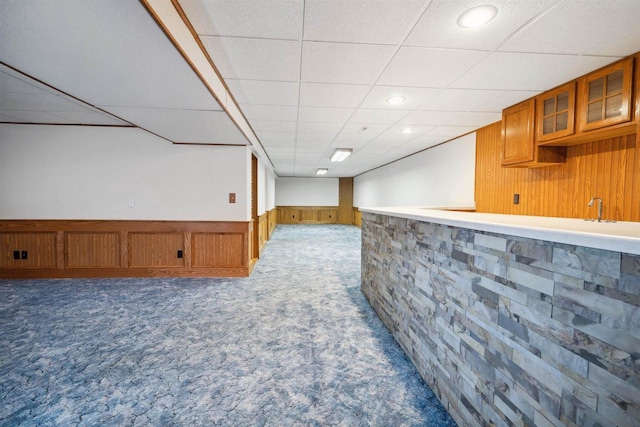 1820 Sampson St, Wisconsin Rapids, WI 54494 - finished basement with bar, wood walls, carpet floors, a drop ceiling, and a wainscoted wall