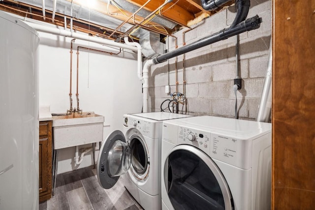 1820 Sampson St, Wisconsin Rapids, WI 54494 - laundry room with washing machine and clothes dryer, wood finished floors, and concrete block wall