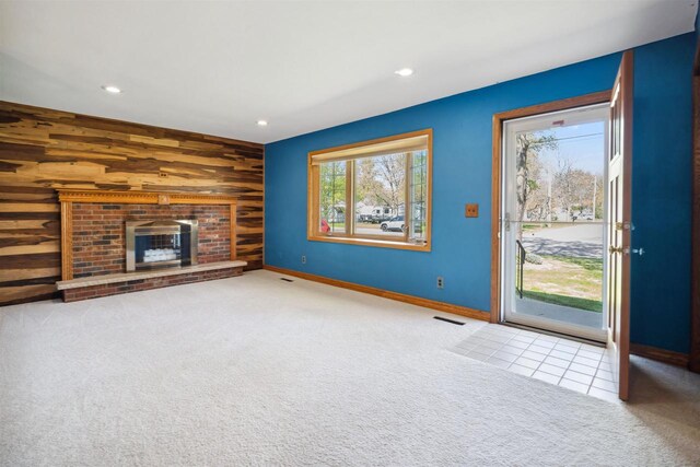 1820 Sampson St, Wisconsin Rapids, WI 54494 - unfurnished living room featuring carpet floors, wood walls, recessed lighting, a brick fireplace, and baseboards