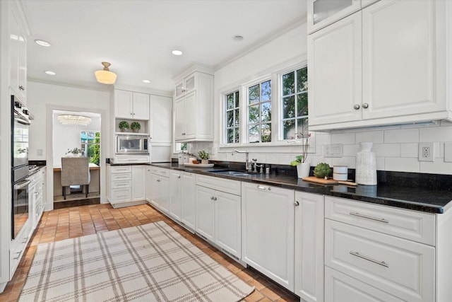3468 N Summit Ave, Milwaukee, WI 53211 - kitchen with backsplash, white cabinets, a sink, glass insert cabinets, and ornamental molding