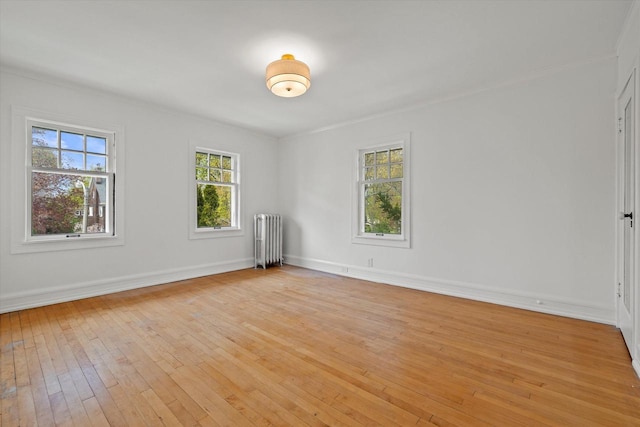 3468 N Summit Ave, Milwaukee, WI 53211 - spare room with radiator heating unit, light wood-style floors, ornamental molding, and baseboards