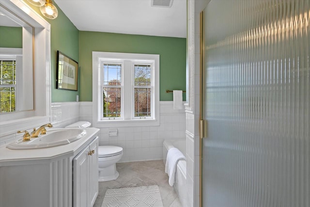 3468 N Summit Ave, Milwaukee, WI 53211 - bathroom with healthy amount of natural light, a wainscoted wall, toilet, vanity, and tile walls