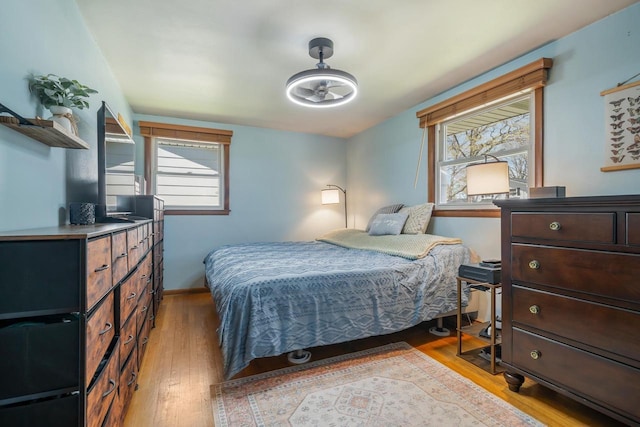 1083 Kenwood St, Green Bay, WI 54304 - bedroom with light wood-style floors, multiple windows, and baseboards