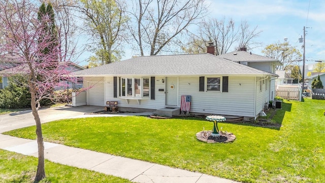 1083 Kenwood St, Green Bay, WI 54304 - view of front of house featuring a chimney, driveway, an attached garage, and central air condition unit