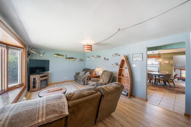 1083 Kenwood St, Green Bay, WI 54304 - living area featuring light wood finished floors, a fireplace, and baseboards