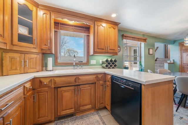 1083 Kenwood St, Green Bay, WI 54304 - kitchen featuring dishwasher, a sink, a peninsula, and light countertops