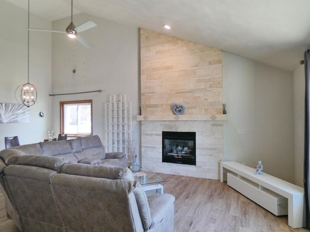 613 S Railroad St, Kimberly, WI 54136 - living area with high vaulted ceiling, wood finished floors, a large fireplace, a ceiling fan, and a chandelier