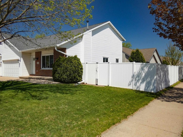 613 S Railroad St, Kimberly, WI 54136 - view of side of property with brick siding, an attached garage, and roof with shingles