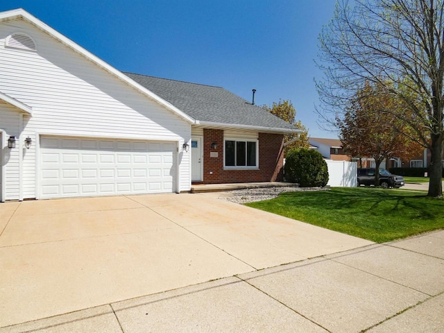 613 S Railroad St, Kimberly, WI 54136 - ranch-style home with brick siding, an attached garage, a front yard, driveway, and a shingled roof