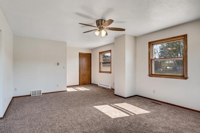 297 Walnut Dr, Onalaska, WI 54650 - spare room with baseboard heating, carpet floors, ceiling fan, and baseboards
