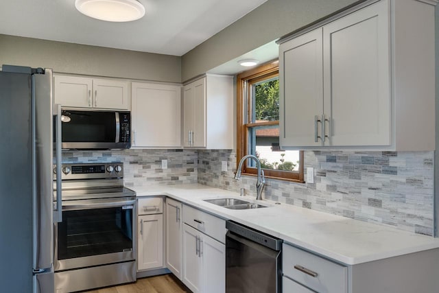 297 Walnut Dr, Onalaska, WI 54650 - kitchen with stainless steel appliances, a sink, decorative backsplash, and white cabinets